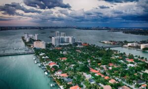 Aerial view of Miami waterfront neighborhoods and high-rises, showing areas where a due diligence survey is essential before buying land