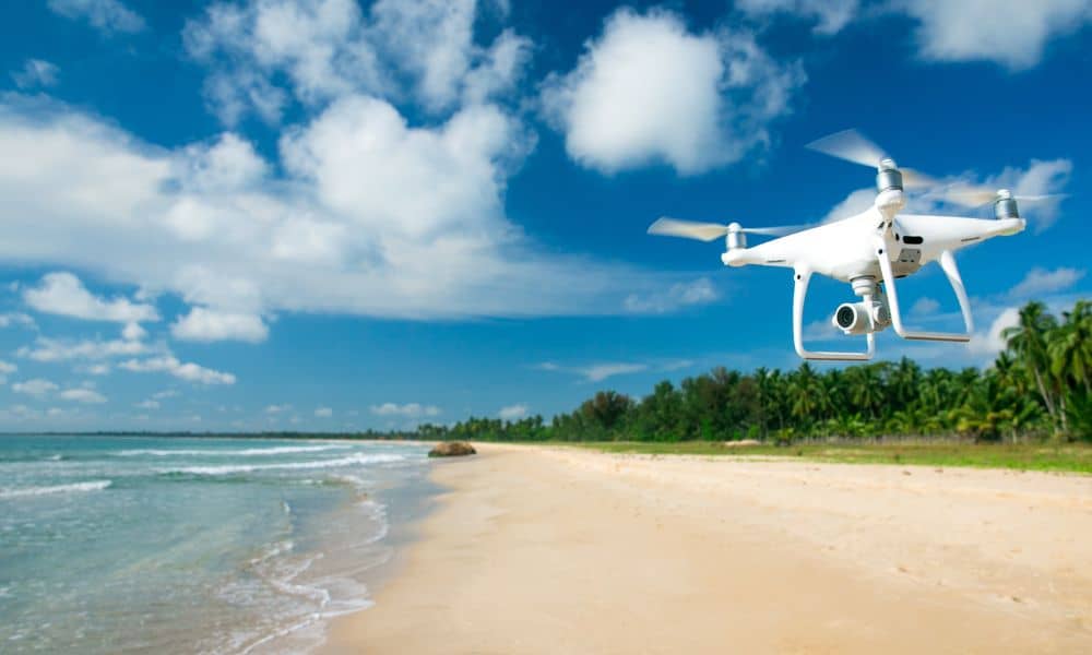 Aerial surveying drone over coastal site - ALTA SURVEY Florida Drone performing aerial surveying along a coastal area to map flood risk