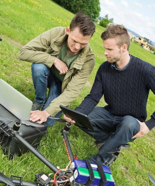 Aerial surveying team analyzing drone data - ALTA SURVEY Florida Surveyors analyzing aerial surveying data from a drone in the field