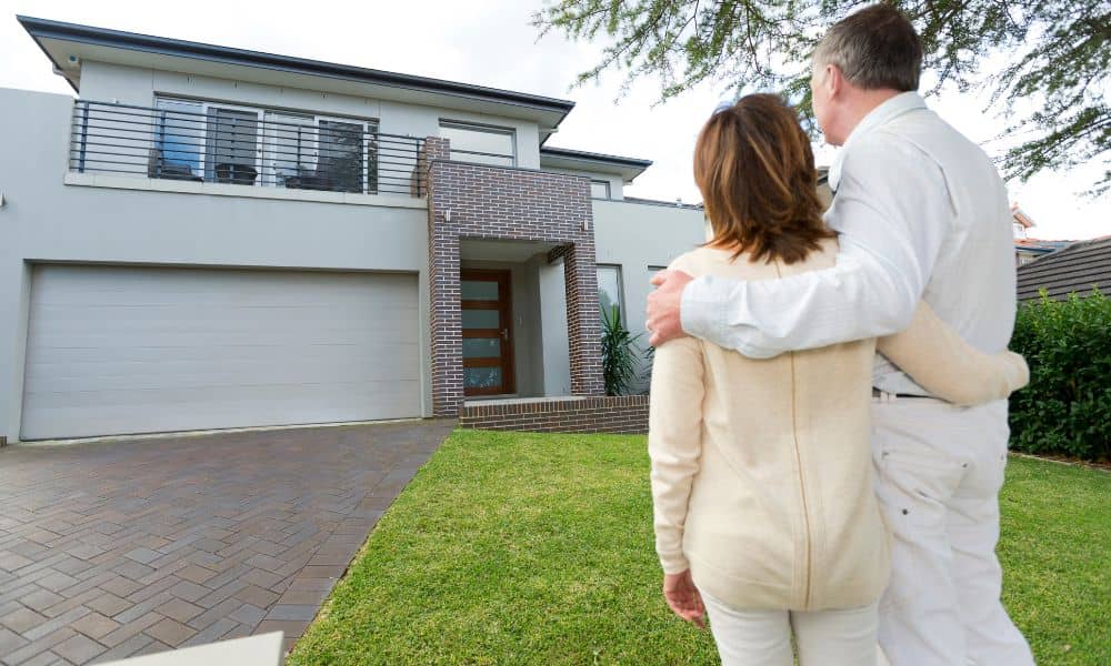 Homebuyers viewing a house exterior before closing on a home