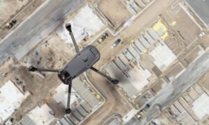 Drone land surveying over a construction site capturing aerial data for mapping and site planning