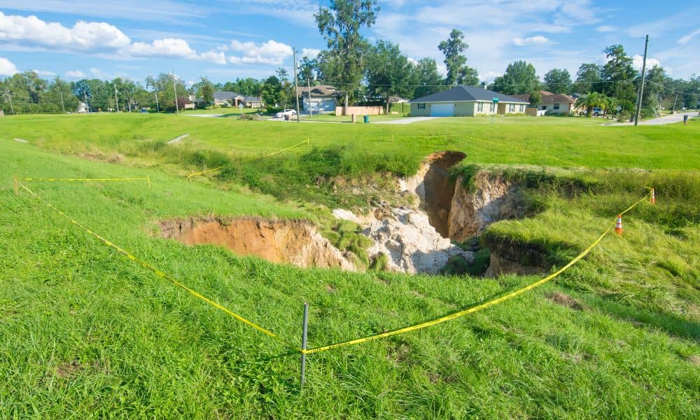 Flood elevation survey helps assess risks when a large sinkhole opens near a home