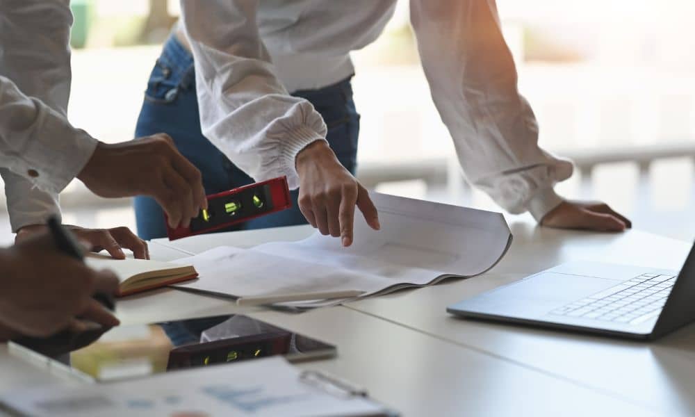 Commercial loan underwriting survey documents - ALTA SURVEY Florida Professionals reviewing documents during a due diligence survey for commercial loan approval