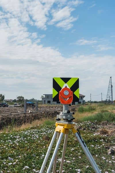 Surveying instrument on site - ALTA SURVEY Florida Surveying instrument set up on a site as part of preparing an ALTA land title survey for zoning-related decisions