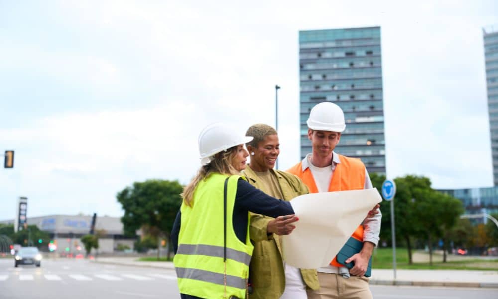 Zoning review team discussing plans - ALTA SURVEY Florida Developers and planners reviewing zoning maps in the city as they discuss why an ALTA land title survey is needed before new rules take effect