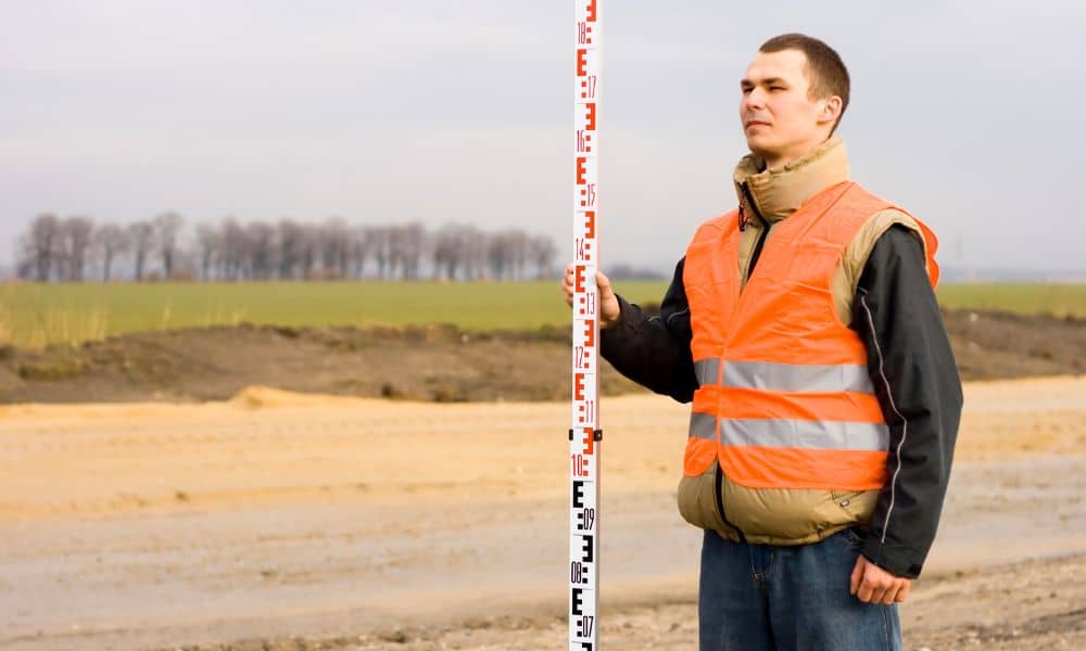 Land surveyor measuring property elevation - ALTA SURVEY Florida Land surveyor measuring property elevation for a FEMA elevation certificate