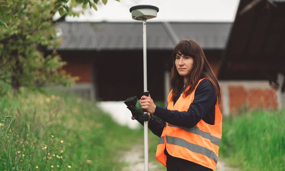 Land surveyor gps measurement residential lot - ALTA SURVEY Florida Surveyor collecting topographic survey data on a residential property before construction