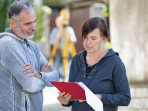Property owner meeting with a land surveying professional while looking for survey companies near me