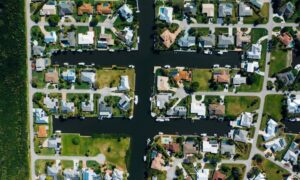 Aerial view of homes and individual lots along a canal, showing the type of property layout a boundary line survey can help clarify